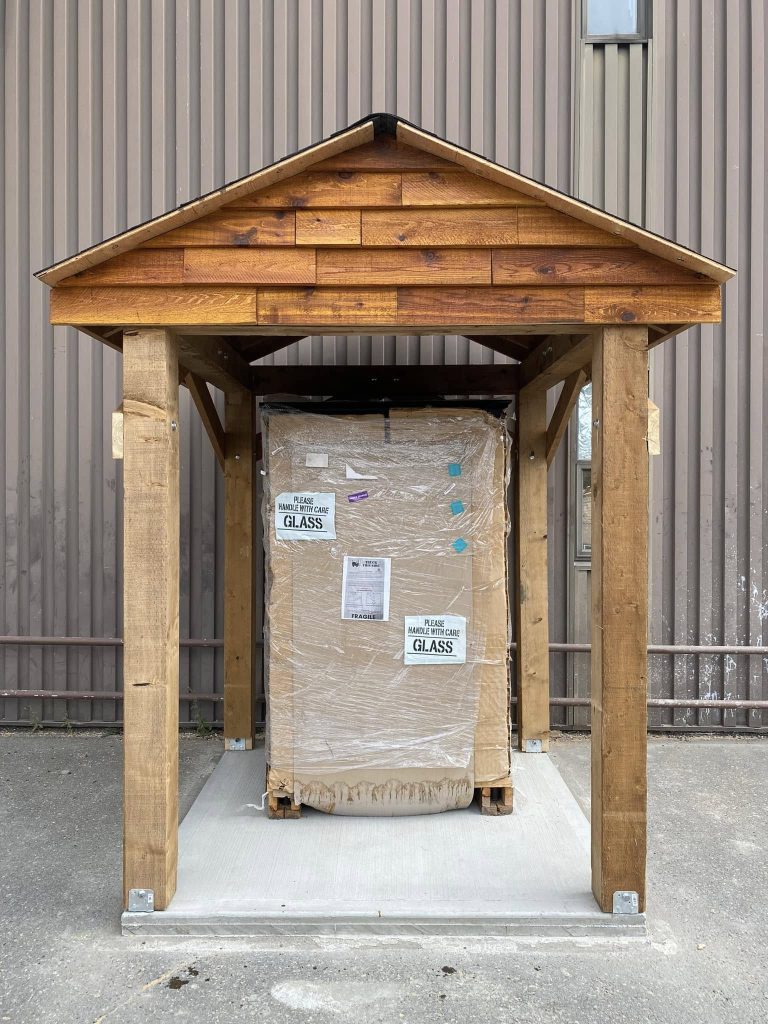 Wooden posts set in the ground for a small structure or fence installation at a residential site.
